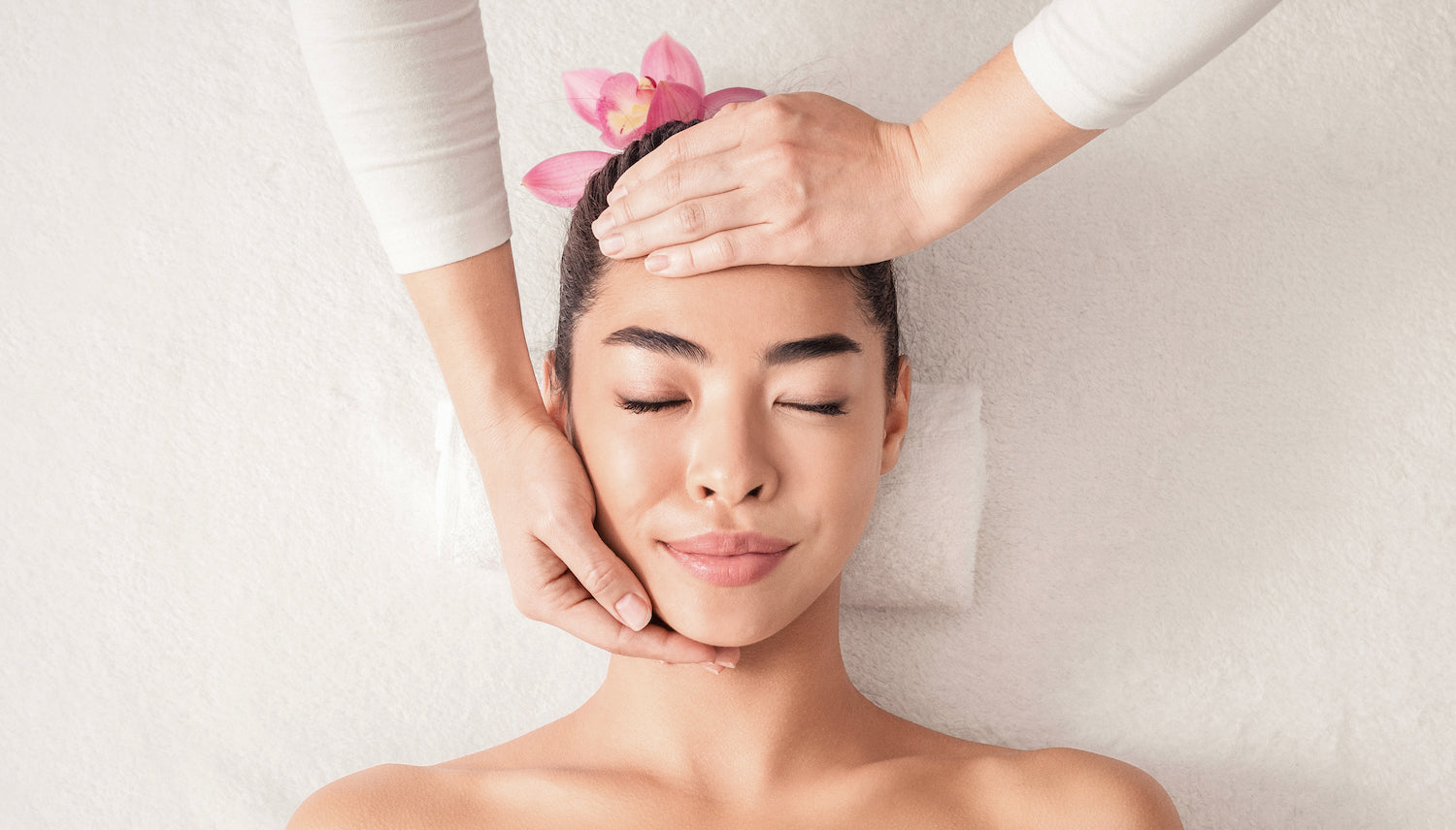 Beautiful woman receiving therapeutic touch by a wellness practitioner.